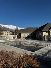 Exterior space with a patio area, fence, and a mountain view