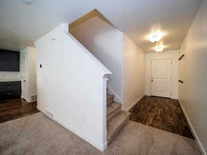 Interior space with visible vents, baseboards, and wood finished floors