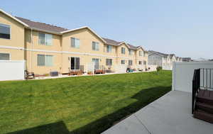 Exterior space featuring a residential view, fence, central AC, and a patio