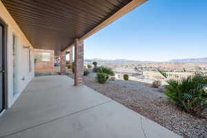 View of patio featuring fence and a mountain view