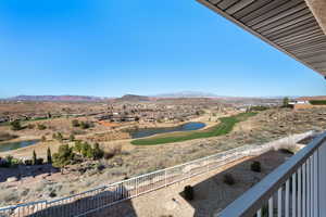 View of mountain feature with view of golf course and a water view