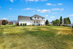 Rear view of property featuring a yard