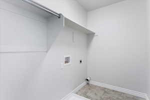 Laundry area with hookup for a washing machine, laundry area, electric dryer hookup, and baseboards