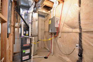 Utilities featuring tankless water heater and heating unit