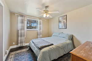 Bedroom featuring a ceiling fan, and wood finished floors