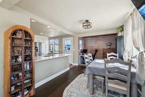 Dining area featuring dark wood-type flooring, and recessed lighting.