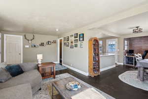 Living area featuring dark wood-style floors