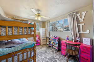 Bedroom featuring a textured ceiling and a ceiling fan