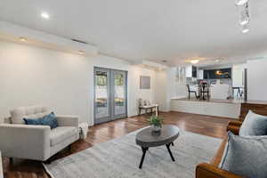 Living room featuring french doors, wood finished floors, visible vents, and track lighting