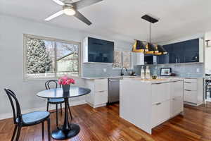 Kitchen featuring dishwasher, light countertops, modern cabinets, and dark wood-style floors