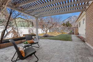 View of patio / terrace featuring a fenced backyard and a mountain view