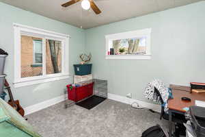 Interior space with a ceiling fan and baseboards