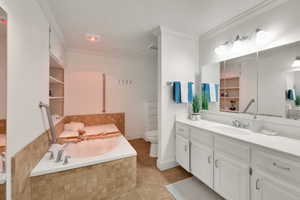 Full bath with vanity, a bath, tile patterned floors, and ornamental molding