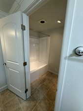 Full bath featuring shower / bathtub combination and light tile patterned floors