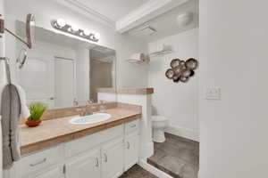 Bathroom featuring crown molding and vanity