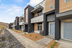 View of building exterior with a residential view and central air condition unit