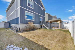 Back of property featuring a yard, a patio, a gazebo, board and batten siding, and a fenced backyard