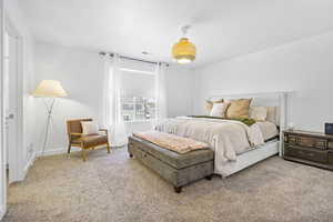 Bedroom featuring carpet floors, visible vents, and baseboards