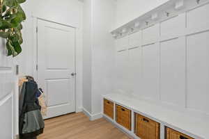 Mudroom featuring light wood-type flooring and baseboards