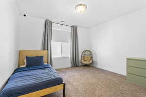 Carpeted bedroom with baseboards and visible vents