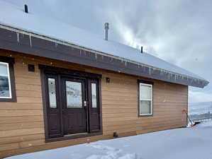 View of snow covered property entrance