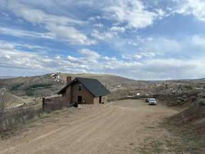 Exterior space with a mountain view and dirt driveway