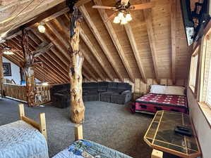 Bedroom featuring carpet, wooden ceiling, and lofted ceiling with beams