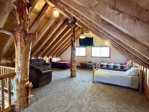 Bedroom featuring lofted ceiling and carpet flooring