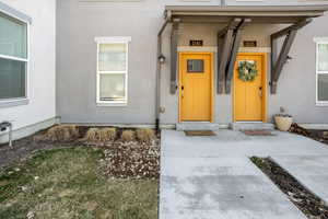 Doorway to property with stucco siding