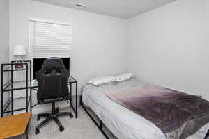 Bedroom with carpet floors and visible vents