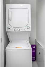 Washroom featuring laundry area and stacked washer and clothes dryer