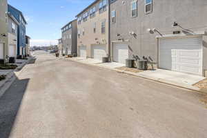 View of road with a residential view, street lights, and curbs