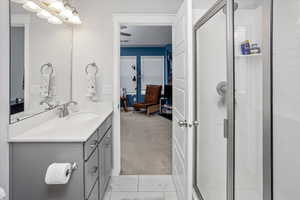 Bathroom with marble finish floor, a shower stall, visible vents, and vanity