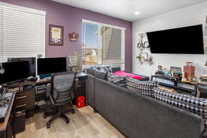 Office area featuring light wood-type flooring and recessed lighting