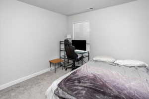 Bedroom with carpet, visible vents, and baseboards