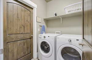 Clothes washing area featuring laundry area and washer and dryer