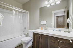 Full bath with shower / tub combination, vanity, and toilet