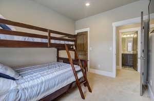 Bedroom with baseboards and light colored carpet