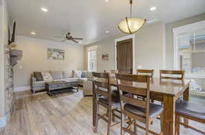 Dining room with recessed lighting, visible vents, light wood-style flooring, a ceiling fan, and baseboards