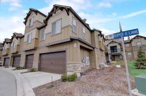 Exterior space featuring a garage, concrete driveway, and a residential view