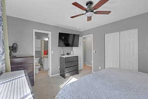 Owners' suite with ceiling fan and roomy closets