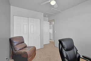 Office area featuring attic access and light colored carpet