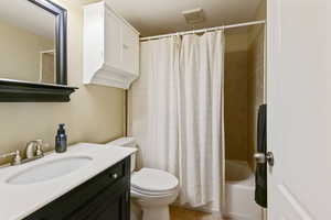 Full bath with toilet, vanity, visible vents, tile patterned floors, and shower / bath combo