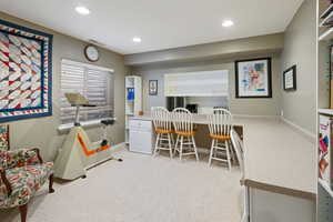 Office space with baseboards, light carpet, visible vents, and recessed lighting