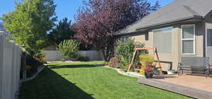 View of yard with a wooden deck and a fenced backyard