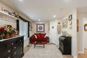 Sitting room with light tile patterned floors, baseboards, and recessed lighting
