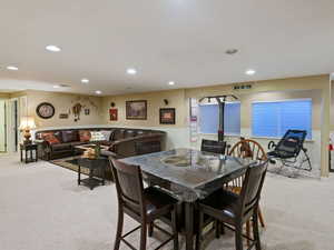 Dining room featuring recessed lighting and light colored carpet