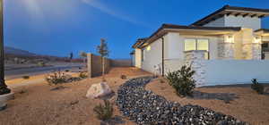 View of property exterior with fence and stucco siding