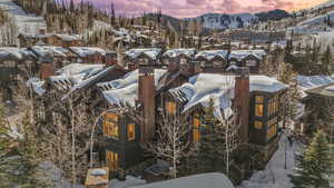 View of snow covered exterior featuring a residential view and a mountain view