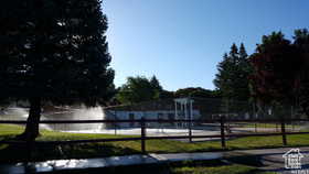 View of property's community with a water view and fence
